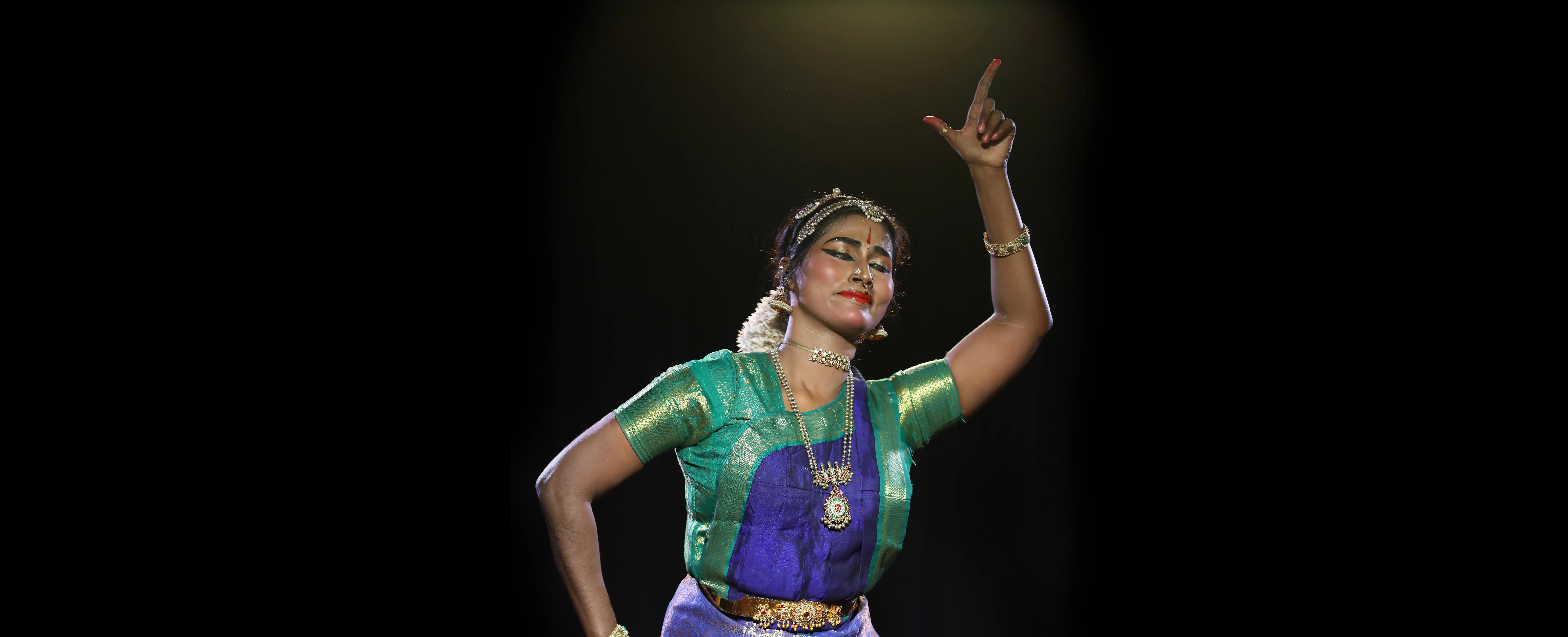 Bharatanatyam artist in performance — embodying conscious movement